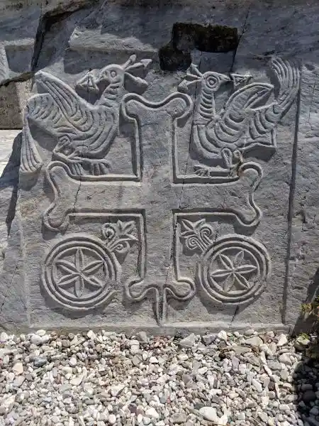 Byzantine marble relief featuring a cross flanked by peacocks and floral rosettes
